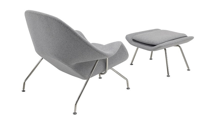Sillón Noma de diseño envolvente con respaldo curvado y estructura metálica